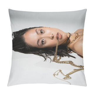 Personality  Young Asian Woman With Short Brunette Hair Holding Golden Jewelry In Mouth While Looking At Camera And Lying On Grey Background, Everyday Makeup, Wet Hairstyle, Brown Eyes Pillow Covers