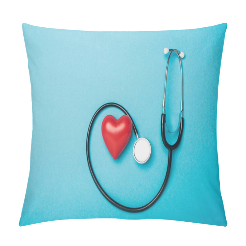 Personality  Top view of decorative heart and stethoscope on blue background, world health day concept pillow covers