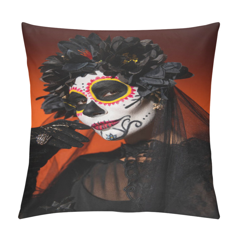 Personality  woman in black wreath and spooky halloween makeup holding hand near face and looking at camera on orange background pillow covers