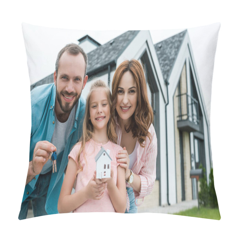 Personality  cheerful kid holding carton house model near father with keys and happy mother  pillow covers