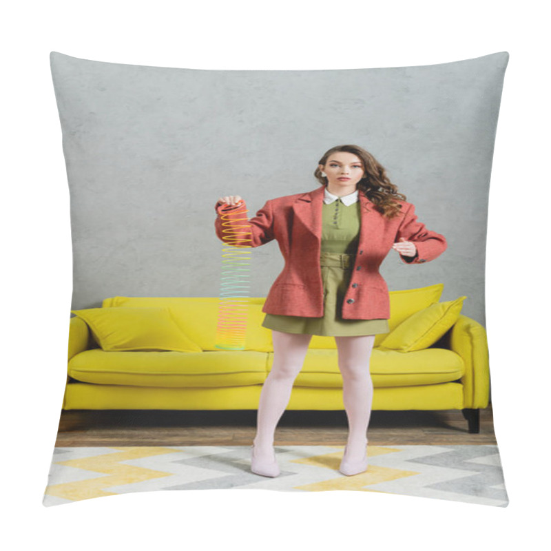 Personality  beautiful woman posing like a doll and playing with rainbow slinky, looking at camera, modern living room with yellow couch, childish, vintage, nostalgia, colorful toy, leisure and fun  pillow covers