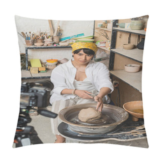 Personality  Young Asian Female Artist In Headscarf And Workwear Looking At Digital Camera While Sitting Near Clay On Pottery Wheel In Ceramic Workshop At Background, Pottery Artist Showcasing Craft Pillow Covers