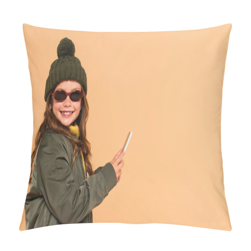 Personality  Cheerful Kid In Sunglasses, Jacket And Knitted Hat Holding Mobile Phone Isolated On Beige Pillow Covers