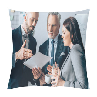 Personality  Businessman Pointing At Paper Near Smiling Businesswoman With Water And Investor With Coffee In Office   Pillow Covers