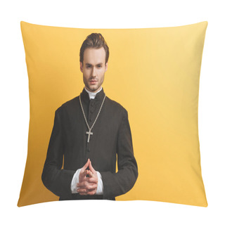 Personality  Serious Catholic Priest Standing With Clenched Hands While Looking At Camera Isolated On Yellow Pillow Covers