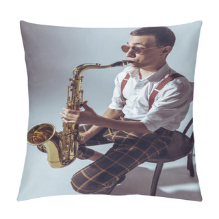 Personality  High Angle View Of Stylish Young Performer Sitting On Chair And Playing Saxophone On Grey Pillow Covers