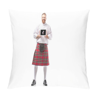 Personality  KYIV, UKRAINE - NOVEMBER 29, 2019: Smiling Scottish Redhead Man In Red Kilt Presenting Digital Tablet With Tiktok App On White Background Pillow Covers