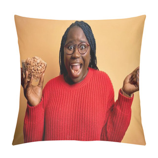 Personality  Young African American Plus Size Woman With Braids Holding Bowl With Healthy Peanuts Screaming Proud And Celebrating Victory And Success Very Excited, Cheering Emotion Pillow Covers