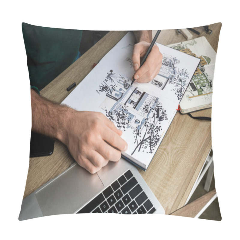 Personality  selective focus of mans hands drawing in album on wooden table next to  utensils pillow covers