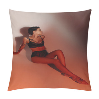 Personality  Full Length Of Tattooed Woman In Sexy Underwear Sitting On Pale Red Background With Shadow Pillow Covers