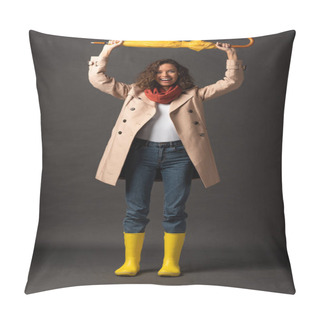 Personality  Happy Woman In Trench Coat And Rubber Boots Holding Yellow Umbrella Above Head On Black Background Pillow Covers