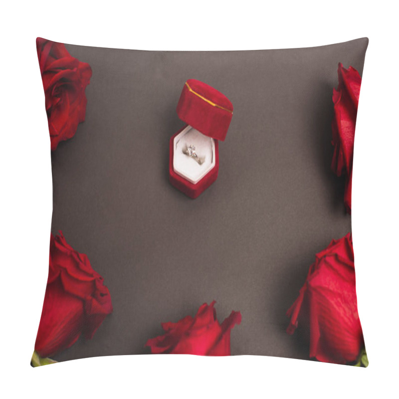 Personality  top view of jewelry box with diamond ring near red roses on black pillow covers