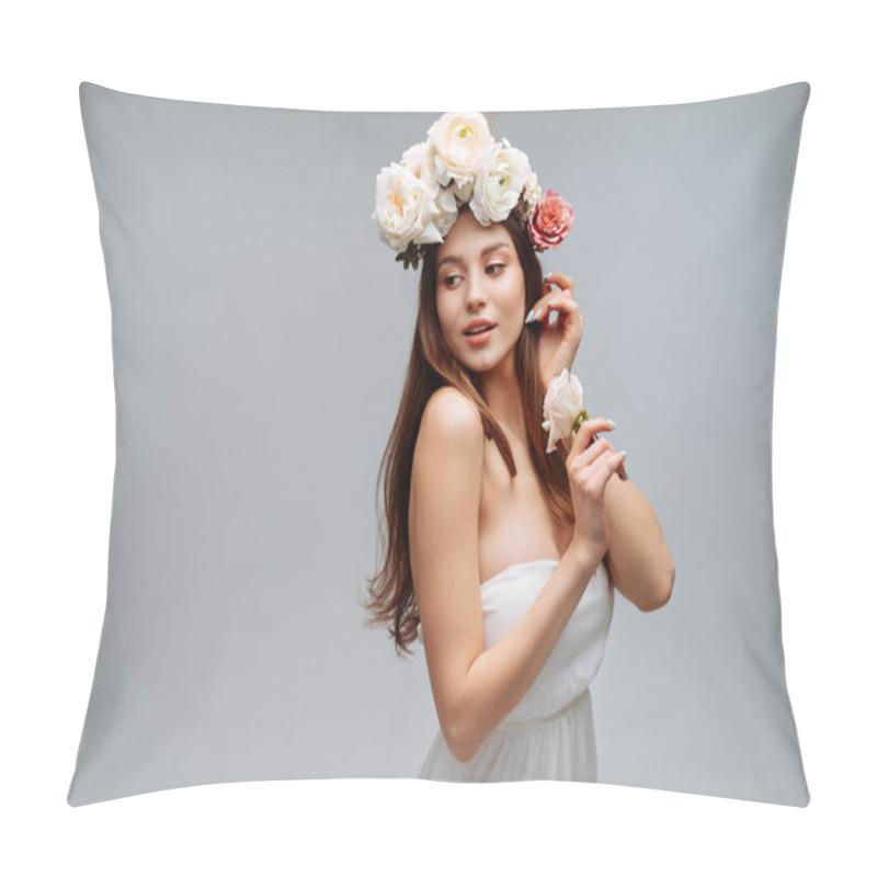 Personality  Beautiful young girl smiling and posing with flowers on gray background in white dress. Studio portrait. pillow covers