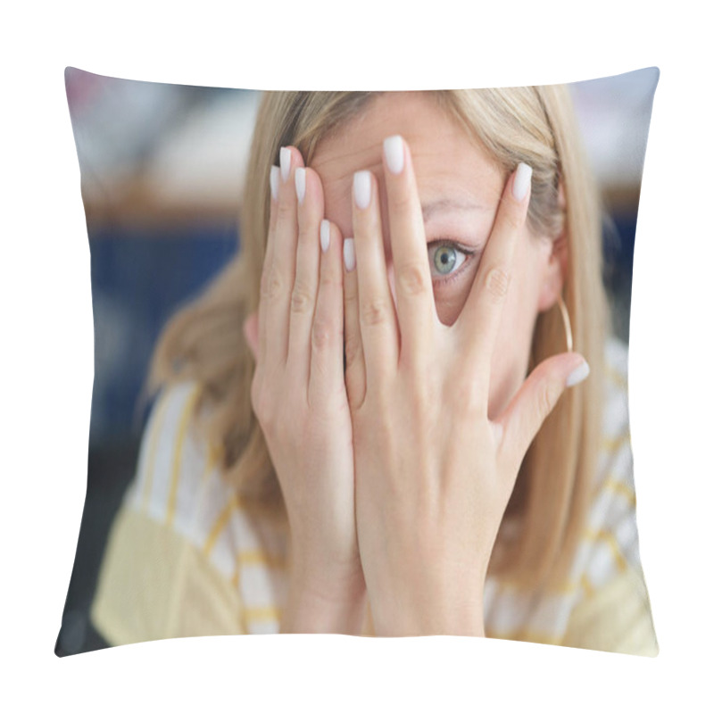 Personality  Woman covers face with her hand looking through fingers closeup pillow covers