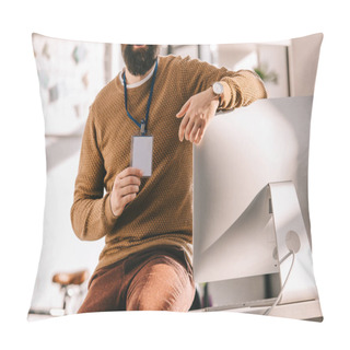 Personality  Cropped View Of Bearded Adult Businessman Sitting On Desk And Holding Blank Security Tag In Office Pillow Covers