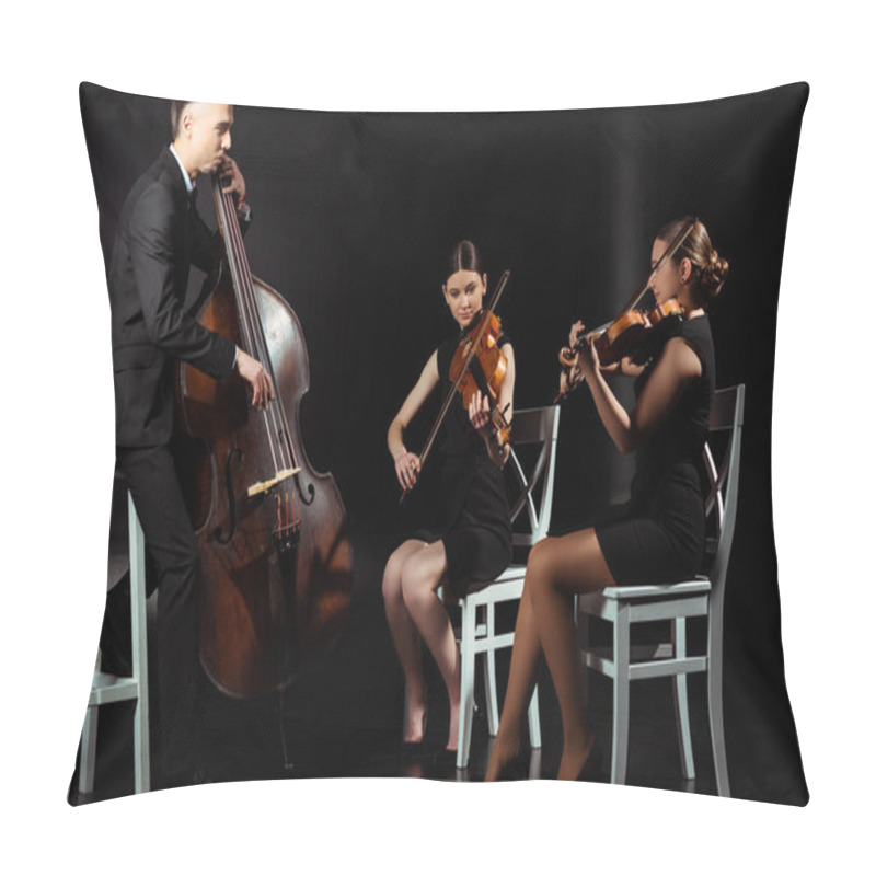 Personality  trio of professional musicians playing on musical instruments on dark stage pillow covers