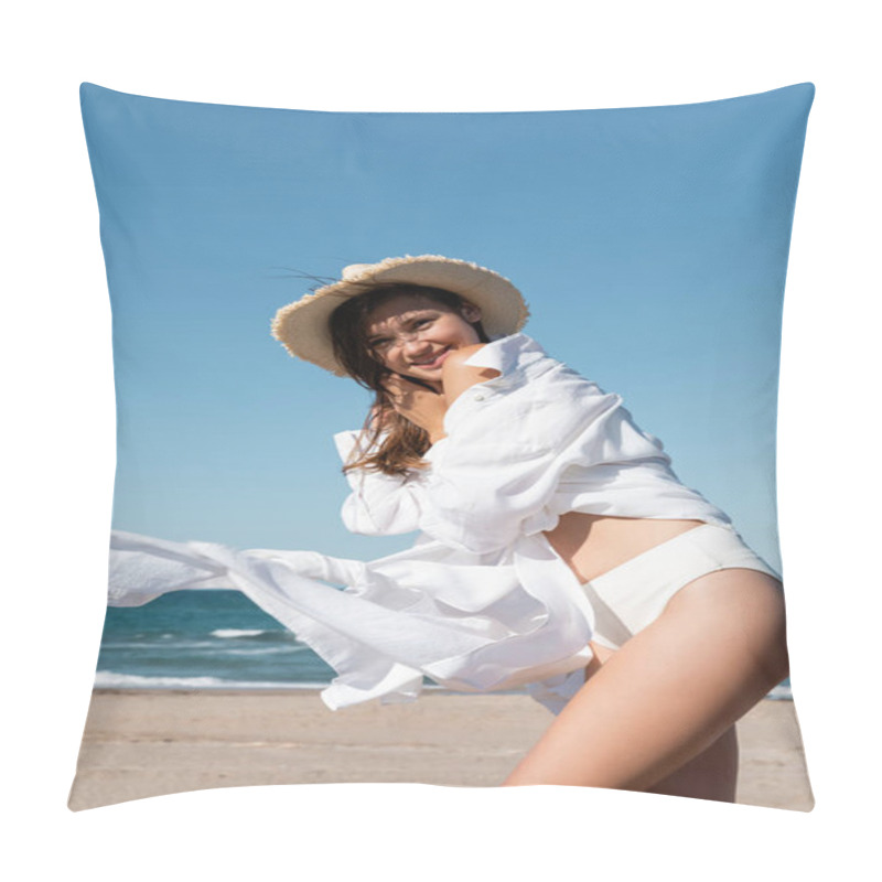Personality  positive young woman in white shirt holding sun hat near blue sea pillow covers