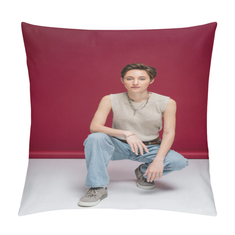 Personality  Full Length Of Pretty Young Woman With Short Hair Sitting On Haunches On Dark Red Background Pillow Covers