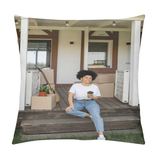 Personality  Cheerful African American Woman With Coffee To Go Sitting On Porch Near Boxes And New House Pillow Covers