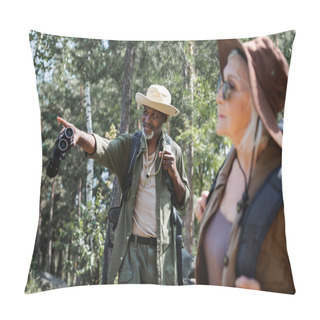 Personality  Smiling African American Man With Binoculars Pointing With Finger Near Blurred Wife In Forest  Pillow Covers