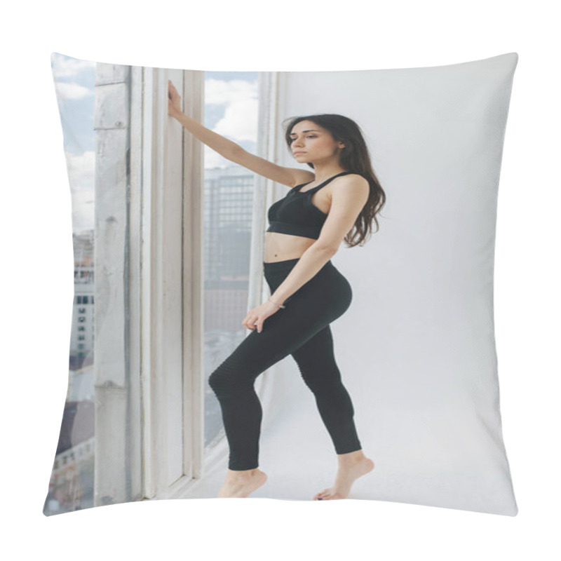Personality  full length view of sportive armenian woman looking through window at home pillow covers