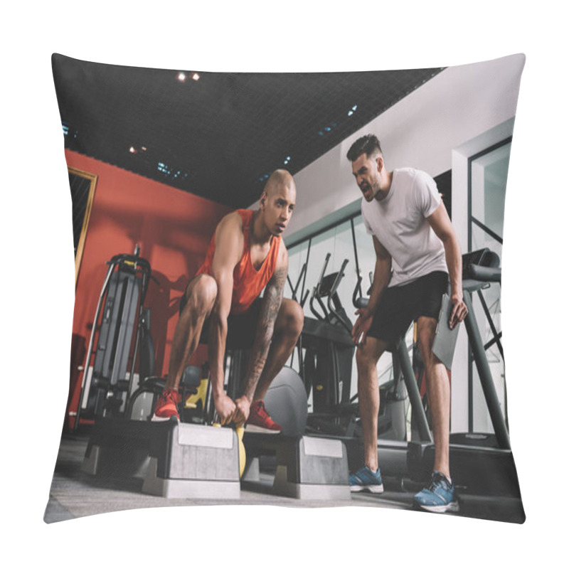 Personality  excited trainer shouting while motivating african american sportsman lifting weight pillow covers