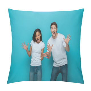 Personality  Cheerful Interracial Couple Showing Frightening Gestures At Camera On Blue Background Pillow Covers