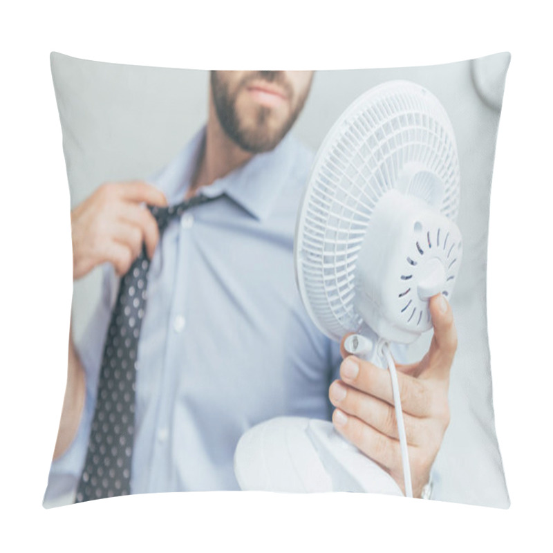 Personality  cropped view of businessman cooling himself with electric fan   pillow covers