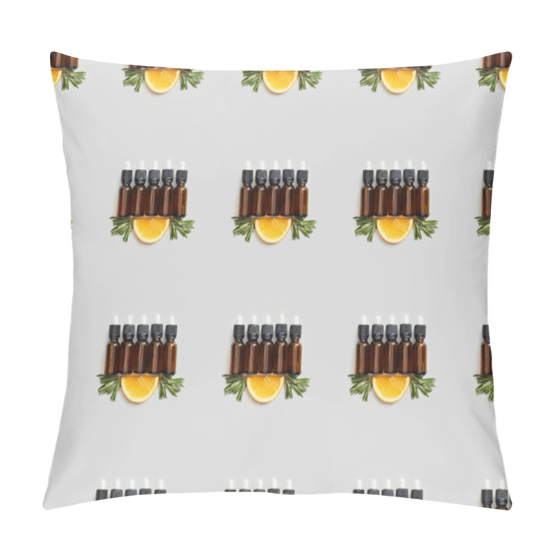 Personality  Pattern with glass bottles of essential oil and cut orange on grey pillow covers