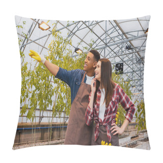 Personality  African American Farmer In Gloves Pointing With Hand Near Cheerful Colleague In Greenhouse  Pillow Covers
