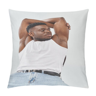 Personality  A Young Man, Wearing A White Tank Top And Blue Jeans, Exudes Urban Style In A Studio Setting Against A Grey Background. Pillow Covers