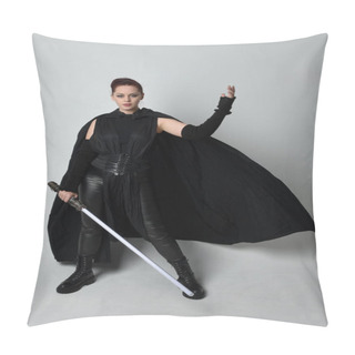 Personality  Full Length Portrait Of Pretty Redhead Female Model Wearing Black Futuristic Scifi Leather Cloak Costume, Holding A Lightsaber Weapon. Dynamic Standing Pose On White Studio Background. Pillow Covers