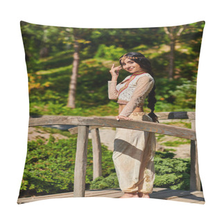 Personality  Positive And Graceful Indian Woman In Ethnic Wear Looking At Camera On Wooden Bridge In Sunny Park Pillow Covers