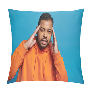 Personality  Thoughtful African American Man In Orange Outfit Touching To Temple With Hands On Blue Background Pillow Covers