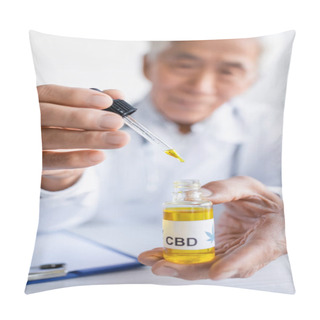 Personality  Cbd Oil In Hands Of Blurred Asian Doctor Near Clipboard In Clinic Pillow Covers