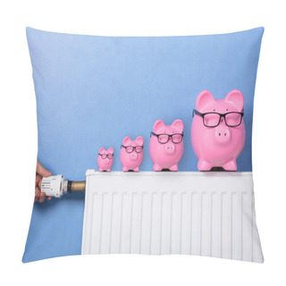 Personality  Close-up Of A Person's Hand Adjusting Thermostat With Piggy Banks Wearing Eyeglasses On Radiator Pillow Covers