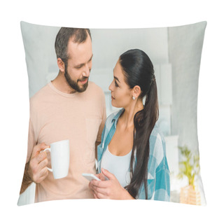 Personality  Wife Using Smartphone While Smiling Husband Holding Cup Of Coffee At Home Pillow Covers