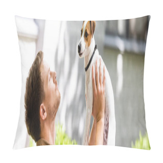 Personality  Panoramic Shot Of Man Raising Jack Russell Terrier Dog On Hands While Standing On Street Pillow Covers