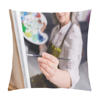 Personality  Partial View Of Mature Woman Holding Paintbrush While Painting On Canvas With Blurred Foreground  Pillow Covers