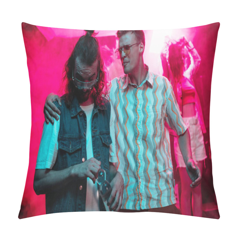 Personality  man in sunglasses hugging another man with water bottle in nightclub during rave party  pillow covers