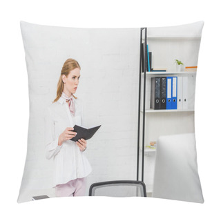 Personality  Serious Young Businesswoman With Book Standing At Modern Office And Looking Away Pillow Covers