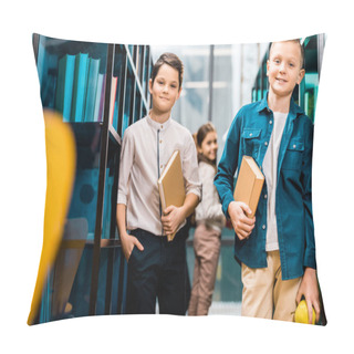 Personality  Adorable Schoolchildren Holding Books And Smiling At Camera In Library  Pillow Covers