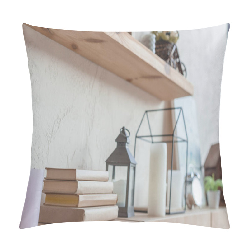 Personality  close-up shot of bookshelf with beautiful decorations and stack of books pillow covers