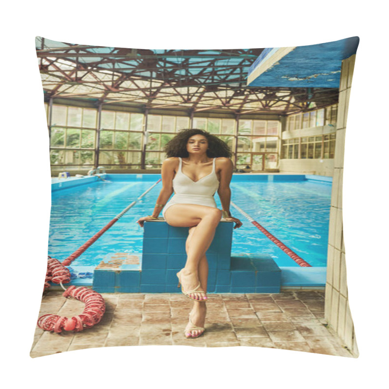 Personality  curly and pretty african american woman in elegant swimwear and high heels sitting by swimming pool pillow covers