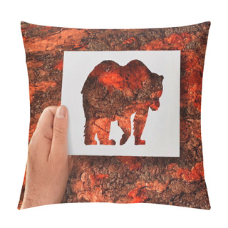 Personality  Man, Flora And Fauna. A Hand Holds A Paper Stencil Of A Bear Against The Background Of A Tree Bark.  Pillow Covers