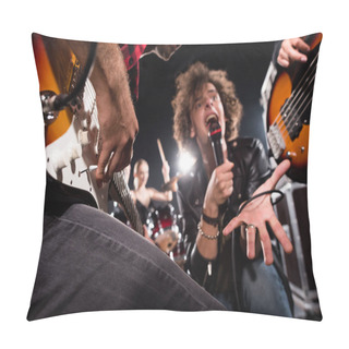 Personality  KYIV, UKRAINE - AUGUST 25, 2020: Low Angle View Of Vocalist Shouting In Microphone Near Guitarists With Backlit On Blurred Background Pillow Covers