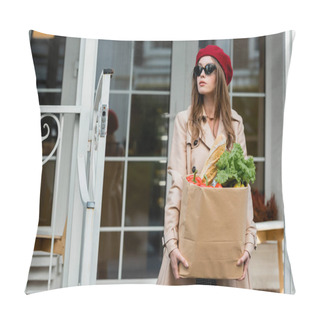 Personality  Young Woman In Beige Trench Coat, Red Beret And Sunglasses Holding Paper Bag With Fresh Groceries Near House  Pillow Covers