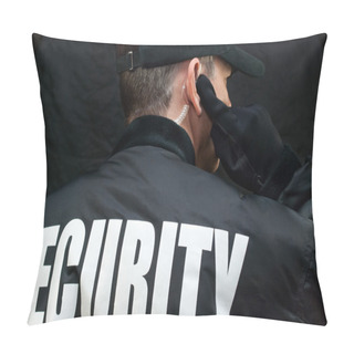 Personality  Security Guard Listens To Earpiece, Back Of Jacket Showing Pillow Covers
