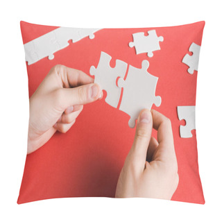 Personality  Cropped View Of Man Connecting White Puzzle Pieces In Hands On Red Pillow Covers