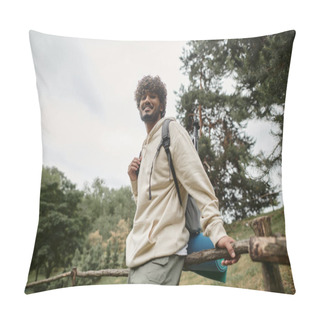 Personality  Low Angle View Of Cheerful Indian Tourist With Backpack Looking At Camera Near Wooden Fence Pillow Covers